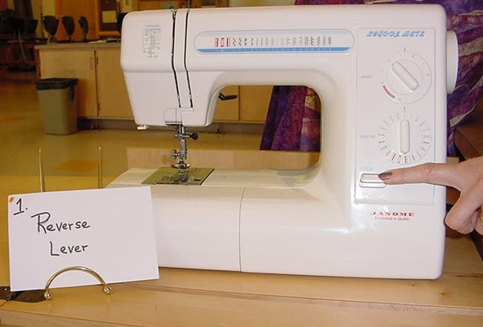 Reverse lever sewing machine